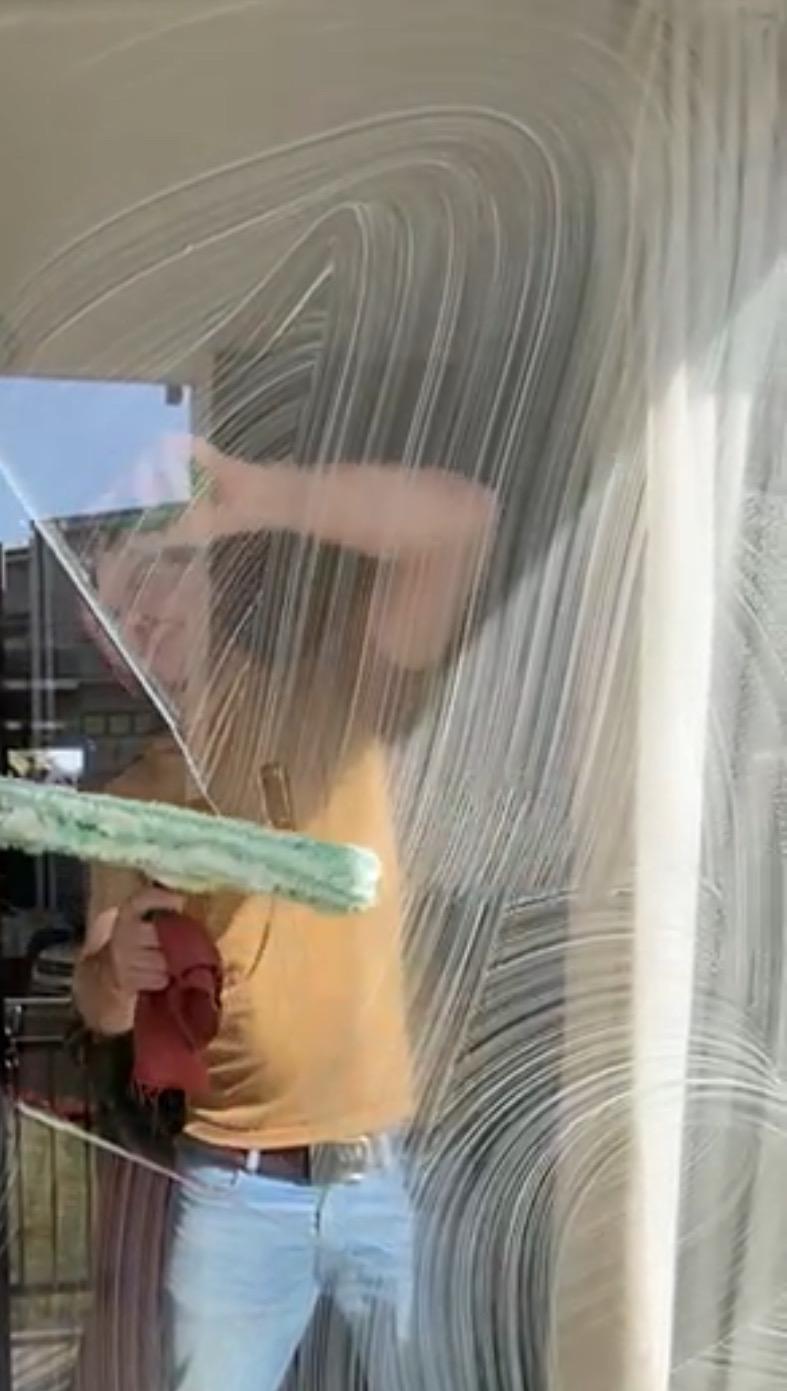 Roy using traditional window cleaning method